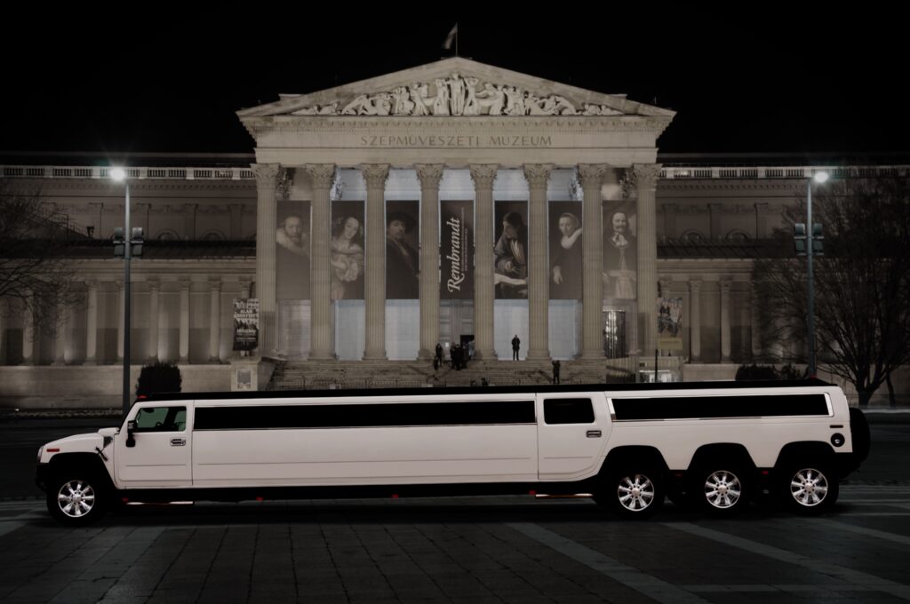 White Hummer limousine in front of the Museum of Fine Arts in Budapest during a stag do night tour.
