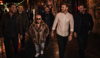 Dwarf performer handcuffed to the groom during a Budapest pub crawl