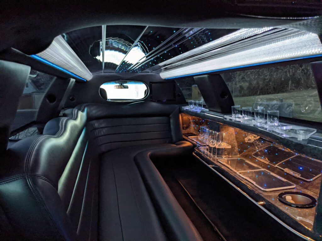 Inside of a limo with glasses and leather seats – sexy airport transfer Budapest rules