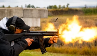 Participant firing an AK-47 during a Rambo Shooting Package in Budapest