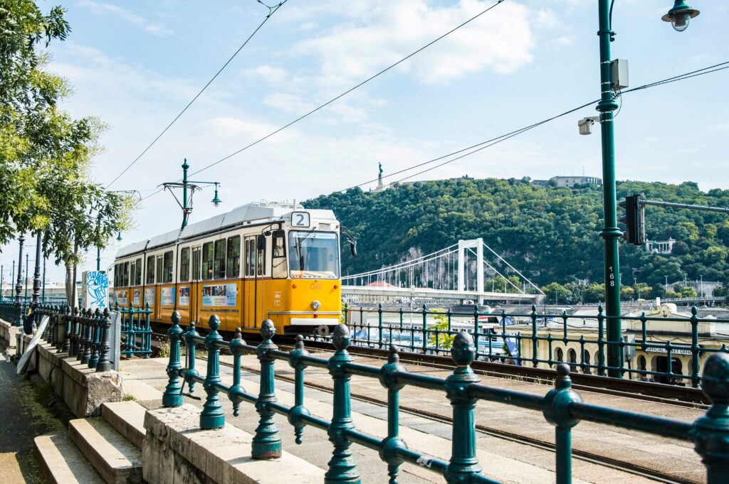 A traditional yellow tram in Budapest near river Danube.