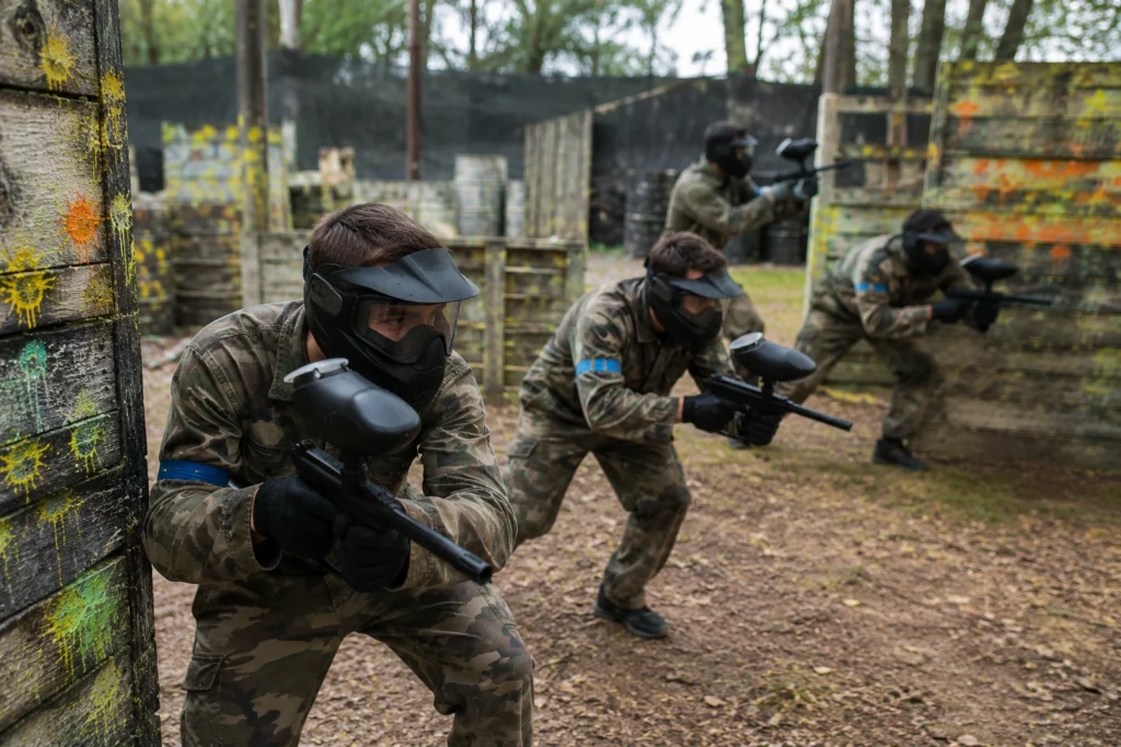 Stag group playing paintball at an outdoor field in Budapest