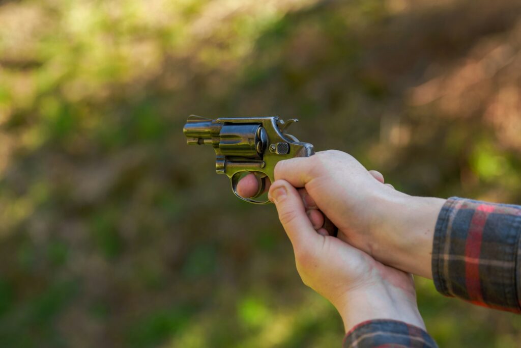 Close-up of a revolver being held outdoors, showcasing a thrilling shooting range experience included in Budapest stag do packages