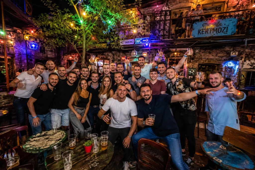 Large group enjoying a night at a Budapest ruin bar