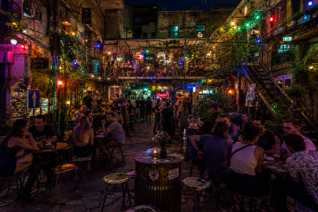 Busy Budapest ruin bar courtyard with colourful lights and eclectic decor