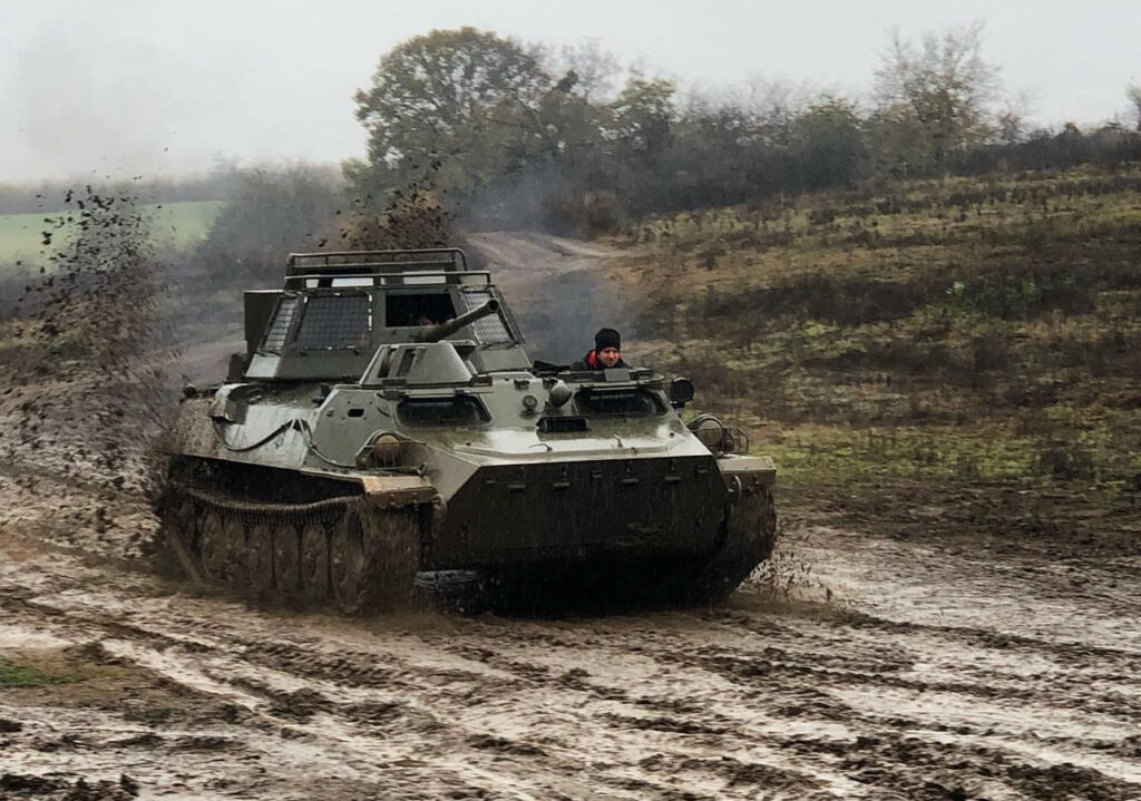 Driving a tank through muddy terrain in Budapest, a thrilling activity perfect for a Budapest vs Prague stag do