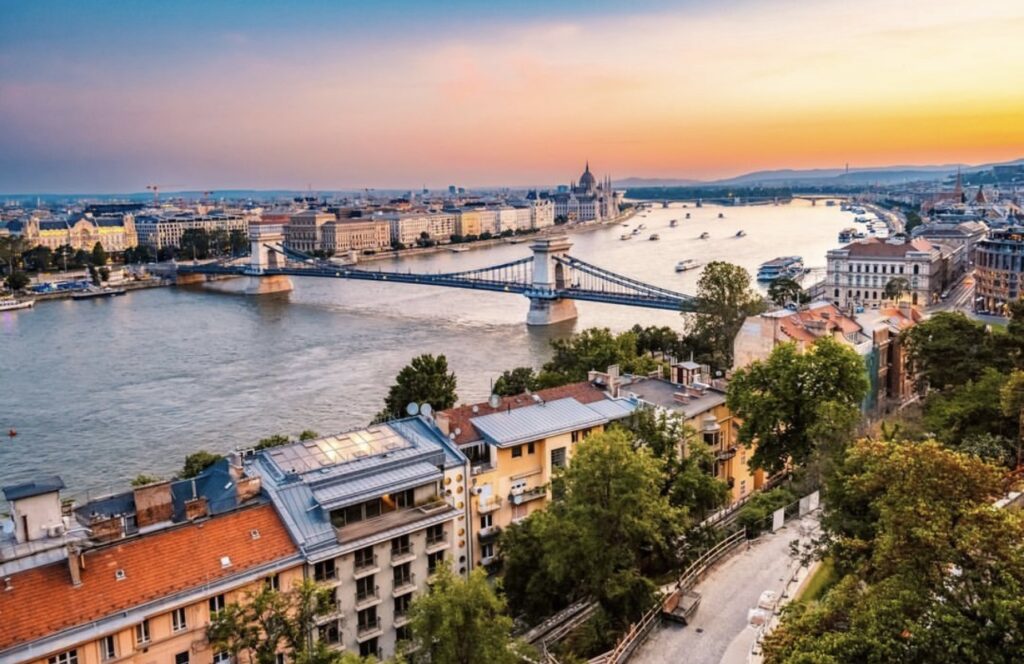 Stunning sunset view of Budapest’s Chain Bridge and the Danube River, a perfect backdrop for a Budapest vs Prague stag do.