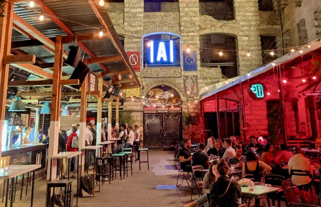 Nighttime scene at a popular Budapest ruin bar, perfect for an exciting Budapest vs Prague stag do experience.