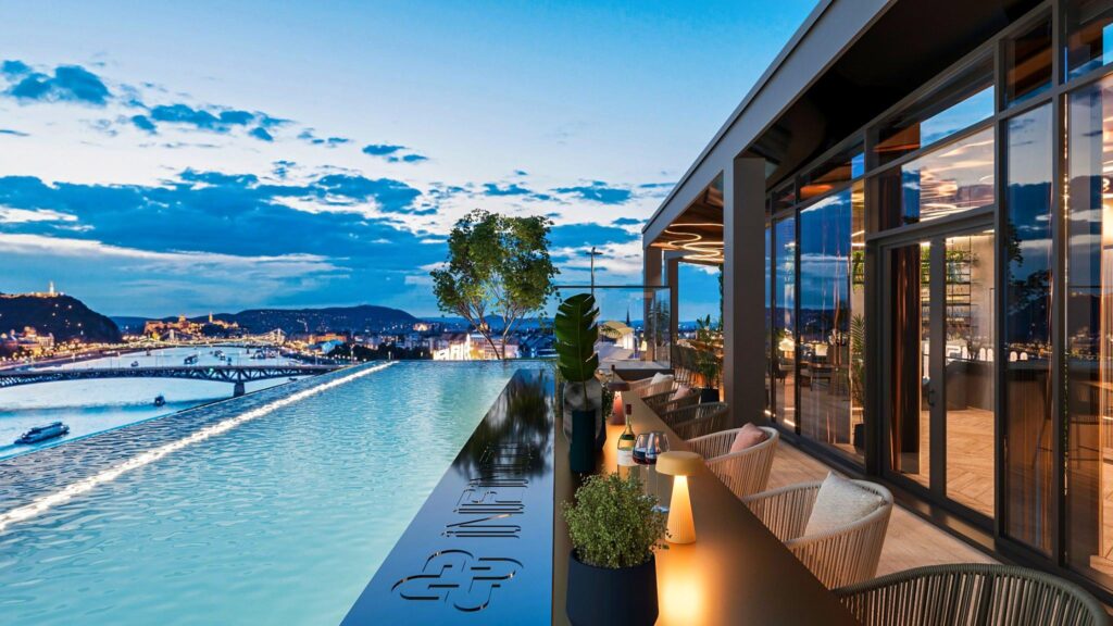 Rooftop bar with a scenic view of Budapest, featuring a sleek design, outdoor seating, and a pool overlooking the Danube River – perfect for a stag do comparing ruin bars vs rooftop bars.