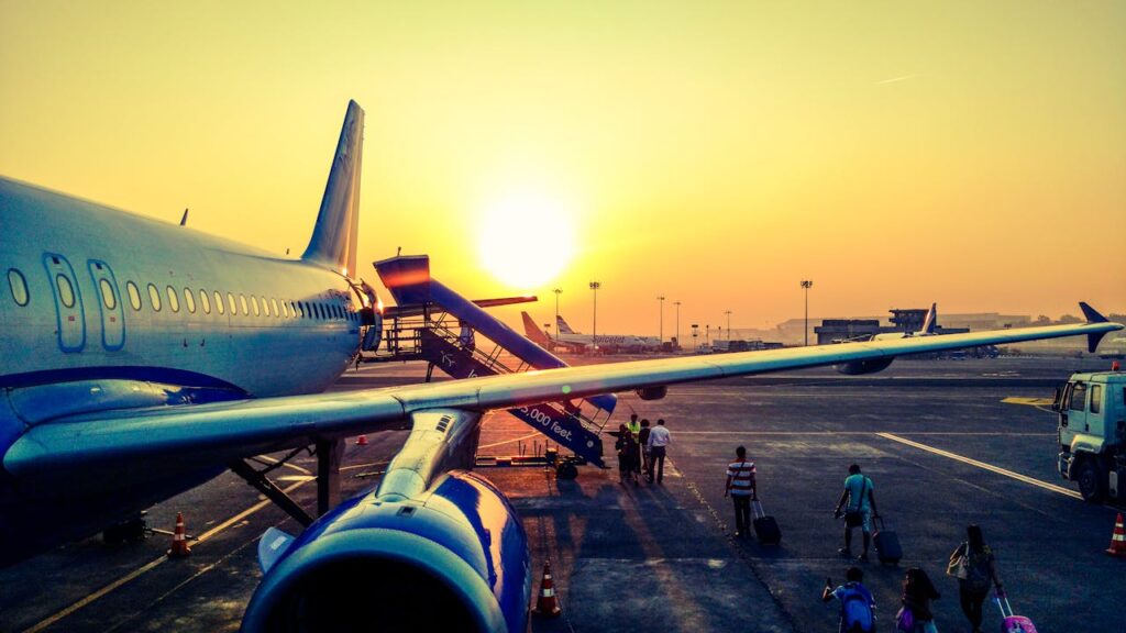 Passengers embarking on a plane at sunrise, capturing the beginning of an unforgettable stag do trip to Budapest with seamless airport transfers