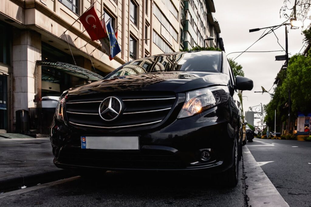 Black Mercedes van parked on a city street, providing a premium transport option for Budapest stag do transfers.