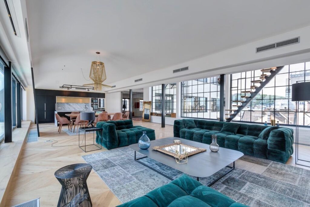 Luxurious penthouse in Budapest with spacious open-plan design and modern furnishings, perfect for bachelor party accommodation with stunning city views.