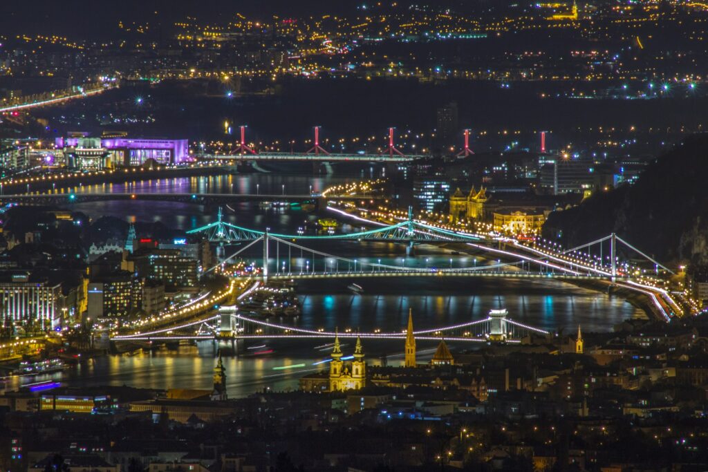 Stunning nighttime view of Budapest's illuminated bridges, showcasing the perfect setting for a Private Riverboat Party on the Danube