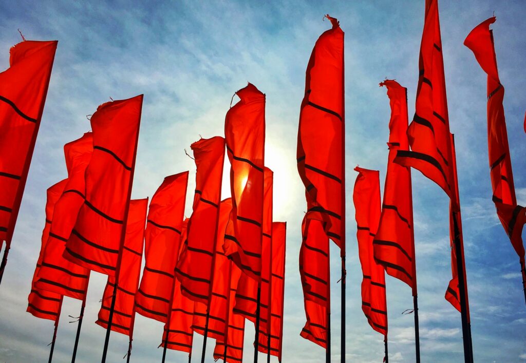 Bright red flags waving, symbolizing Budapest stag do red flags and common pitfalls to avoid