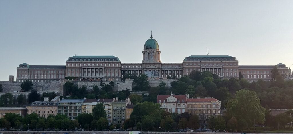 The iconic Buda Castle in Budapest, Hungary, standing majestically on the hill, overlooking the city with its historic architecture and lush surroundings.