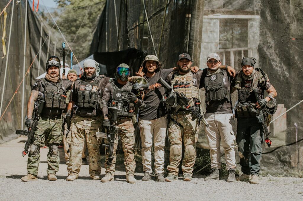 A group of friends fully geared up for an intense paintball match, showcasing teamwork and adrenaline for an unforgettable stag activity.