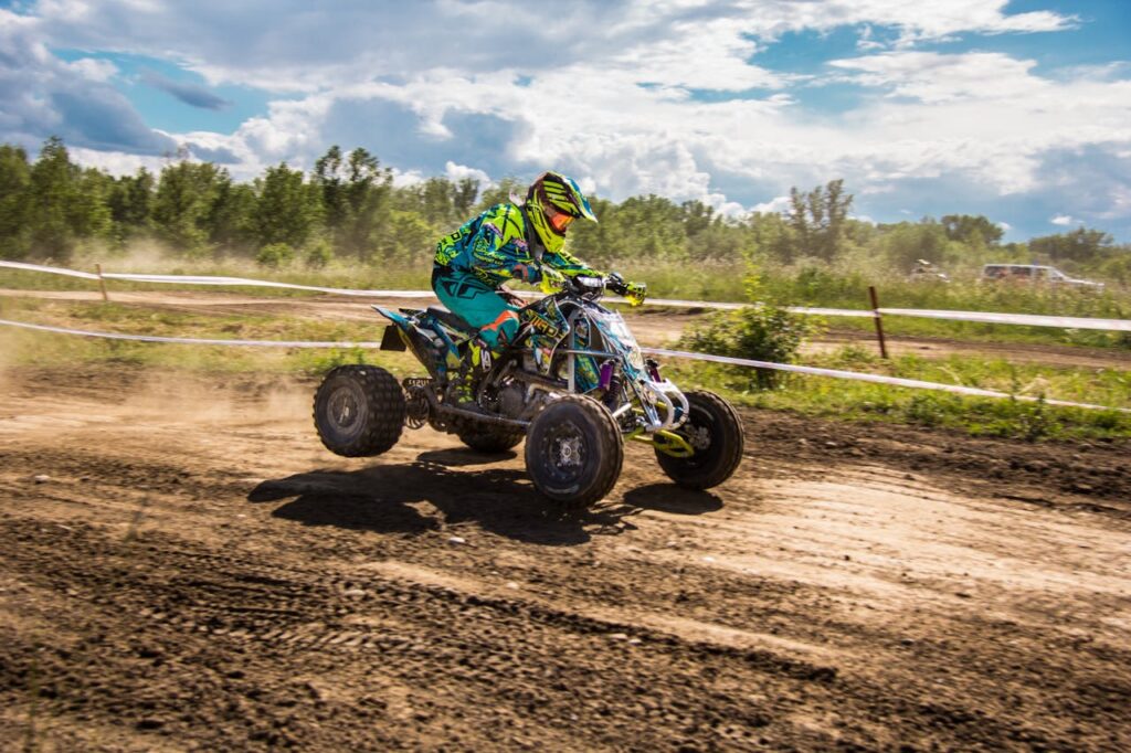 An adventurous rider speeding through a dirt track on a quad bike, enjoying an exhilarating off-road experience one of the top Budapest things to do stag activities