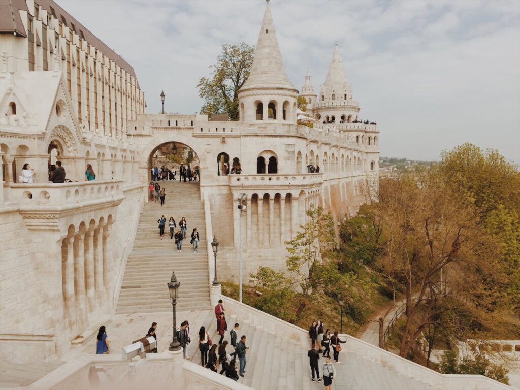 Epic Budapest stag adventures at the Fisherman's Bastion during autumn, with stunning architecture, stairways, and golden-hued trees framing the scene.