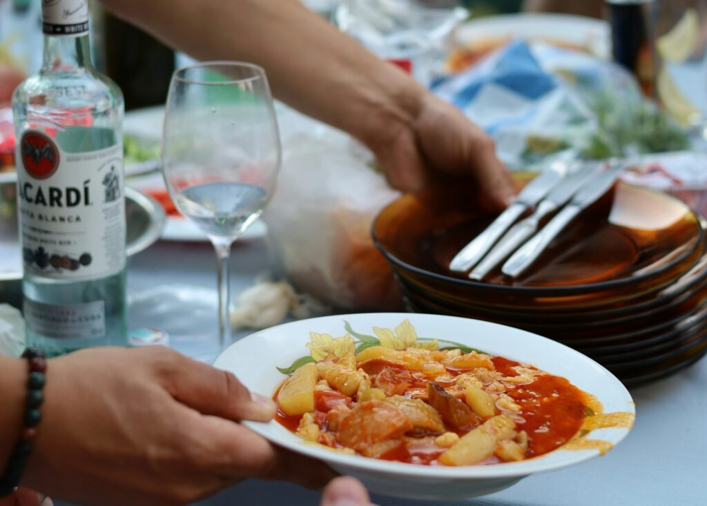 A bowl of Hungarian stew served at an outdoor meal, perfect for a Budapest things to do stag experience