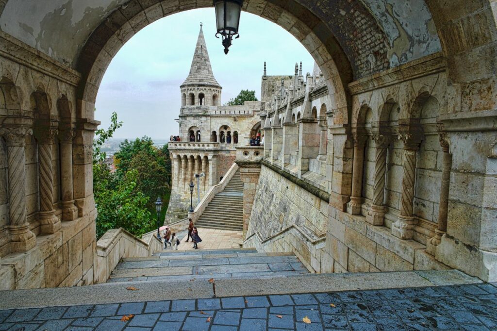 A view through an archway leading to the Fisherman's Bastion in Budapest, a stunning landmark featured in stag party packages Budapest