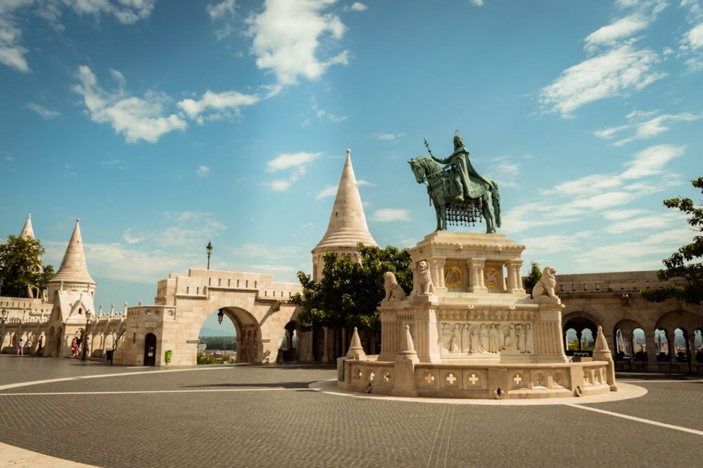 The Fisherman's Bastion in Budapest, Hungary, with the equestrian statue of St. Stephen in the foreground, is a must-visit spot often discussed on Budapest stag do Reddit.